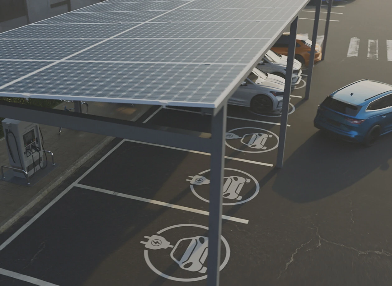 Ein solarbetriebenes Abdach versorgt einen Parkplatz mit E-Ladestationen, an dem mehrere Autos stehen.
